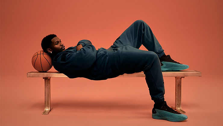 adidas Anthony Edwards laying on a bench with new signature shoes on