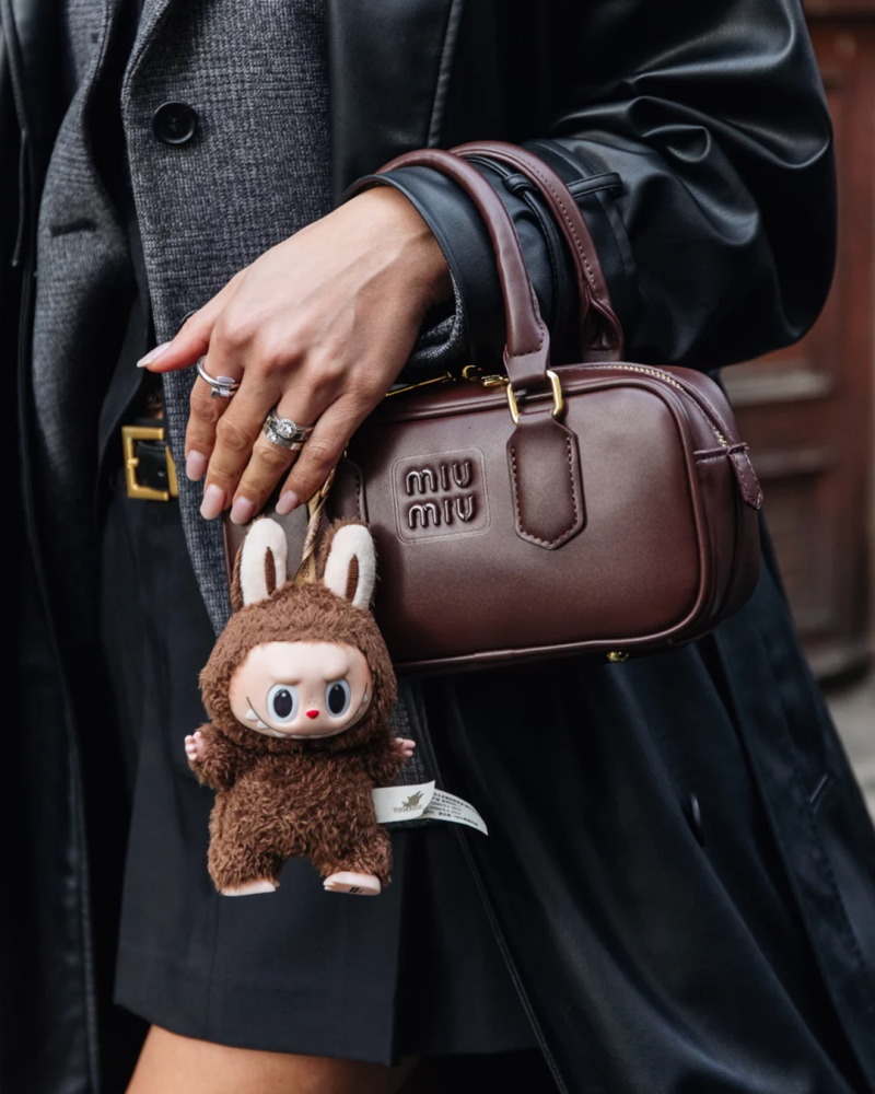 model with labubu and miu miu handbag
