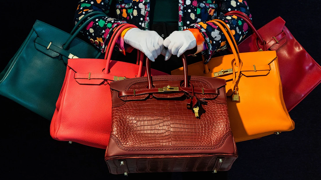 photo of woman holding 5 birkin hermes bags