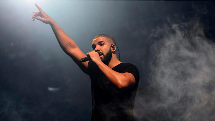 Music artist - Drake, on stage performing, representing contemporary hip-hop.