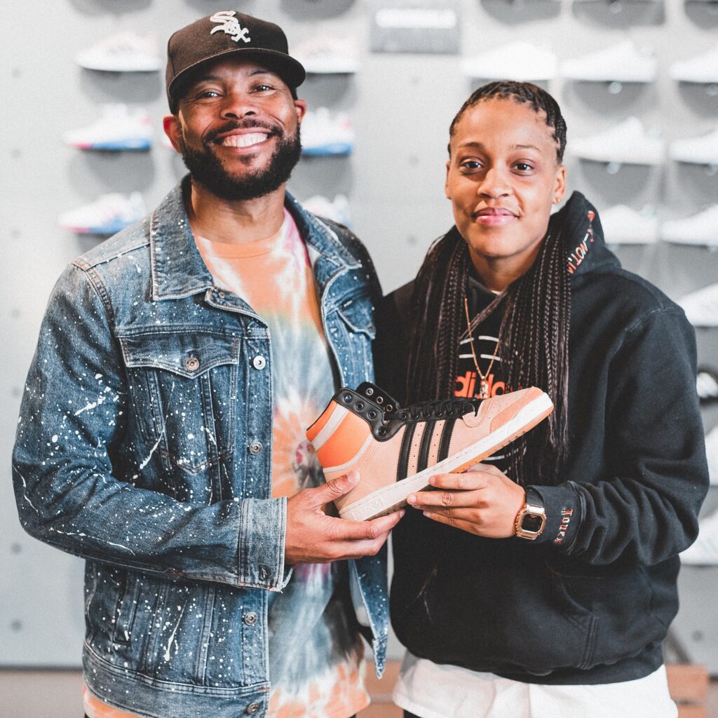 Creative Brand Strategist Kyle Frazier and Creative Jasmine Jones holding Adidas sneaker created by Jasmine